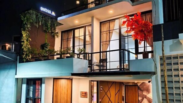 A modern two-story building with a balcony, large windows, and a sign that reads "quattrick." - Quattrick Villa (Batu Sub-District)