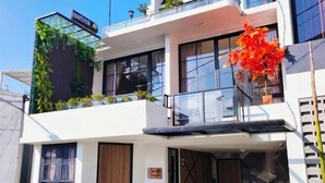 A modern two-story building with a balcony, large windows, and a sign that reads "quattrick". - Quattrick Villa (Batu Sub-District)