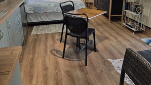 A modern bedroom with a bed, a desk, a chair, and a TV. - Direct water front 3 meters from Lake.
Your own private balcony overlooking Lake (Fennell Bay)