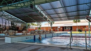 An indoor swimming pool with multiple lanes, lounge chairs, and a covered area with a roof. - Direct water front 3 meters from Lake.
Your own private balcony overlooking Lake (Fennell Bay)