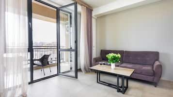 Executive Apartment, Balcony, City View | Living area | 50-inch flat-screen TV with cable channels