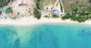 An aerial view of a beach with clear turquoise waters, a sandy shore, and scattered palm trees. - Villa With Private Pool and Mountain Views (Krabi)