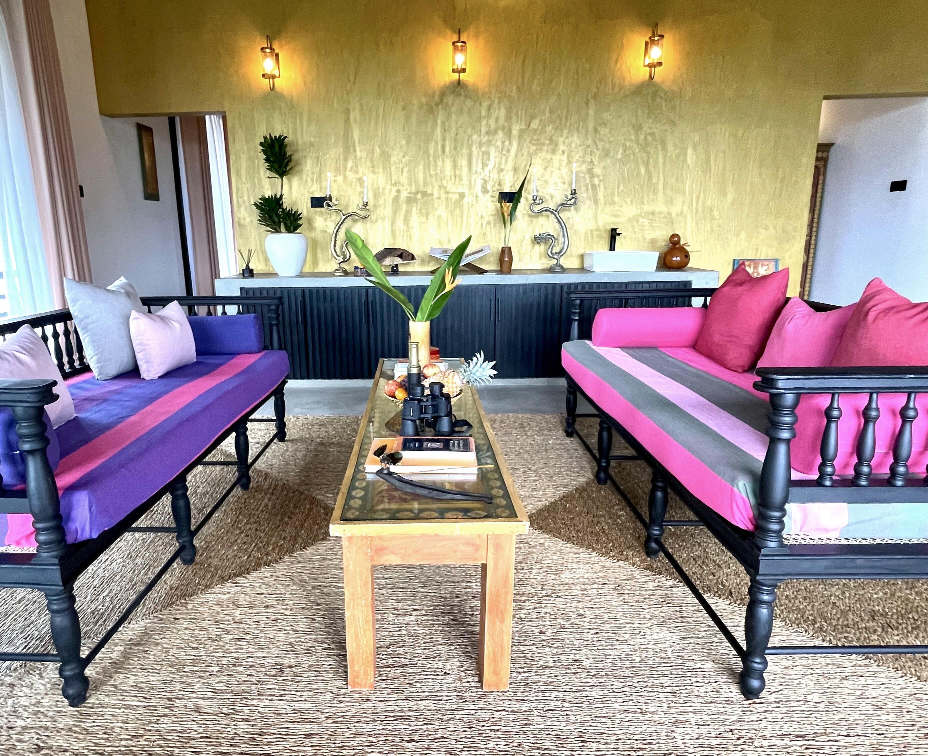 A living room with two sofas, a coffee table, and a decorative vase.