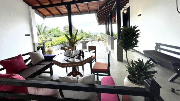 A covered outdoor seating area with a table, chairs, and potted plants. - D' Art Villa Retreat and Spa (Tangalle)