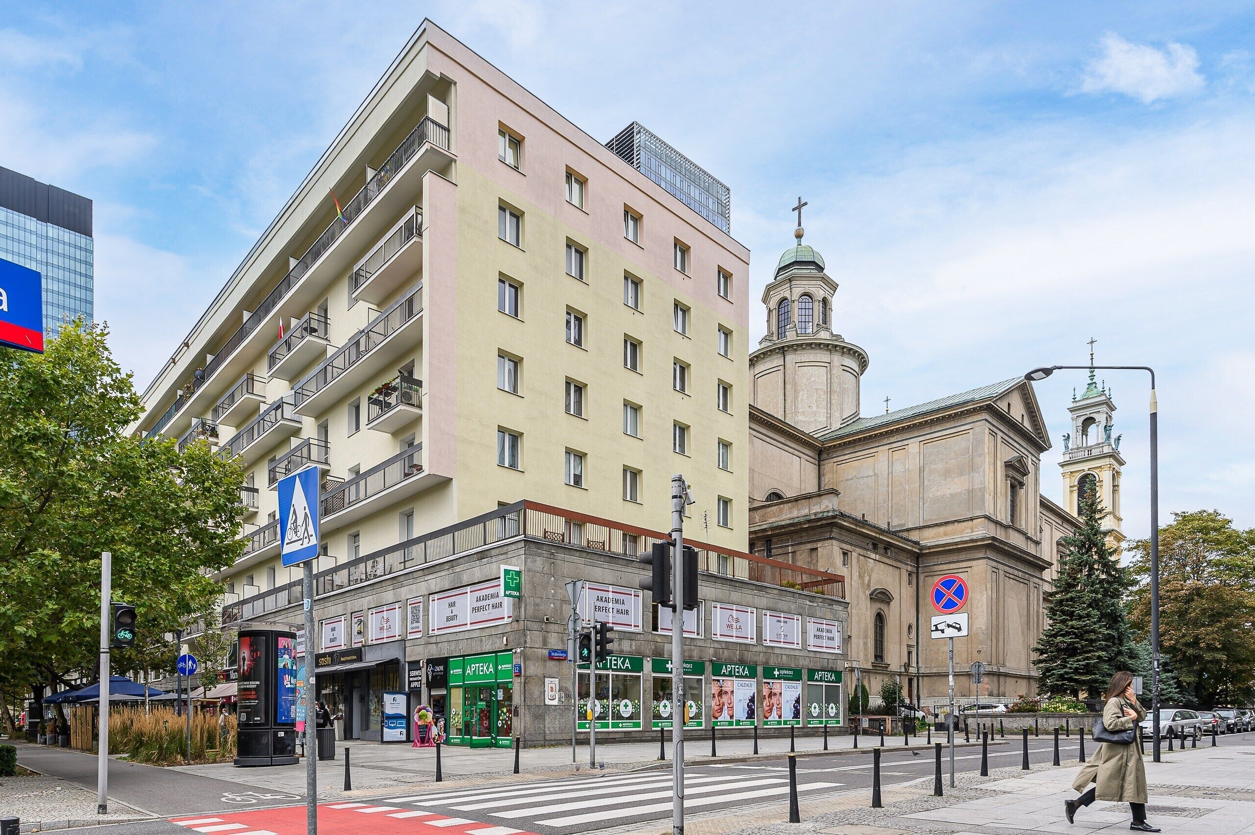A multi-story hotel with a prominent church in the background.