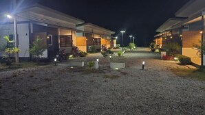 A row of modern, two-story buildings with a gravel driveway and small plants. - Wae Phak Stay Hostel@Khok Kloi (Takua Thung)