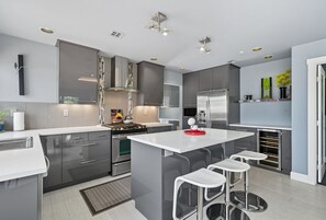 Fridge, oven, stovetop, dishwasher - Top-level duplex featuring a sleek open concept kitchen with stainless appliances, cozy fireplace, stylish furnishings, and in-unit washer/dryer. Designed for basking in the sun under skylights in thoughtful details throughout. (Vancouver)