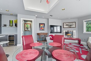 Dining - Top-level duplex featuring a sleek open concept kitchen with stainless appliances, cozy fireplace, stylish furnishings, and in-unit washer/dryer. Designed for basking in the sun under skylights in thoughtful details throughout. (Vancouver)