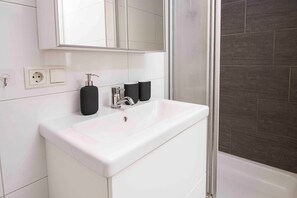 Shower, hair dryer, towels, toilet paper