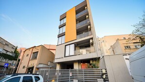 A multi-story building with a modern design, featuring balconies and large windows. - Bucharest Old Town Apartments (Bucharest)