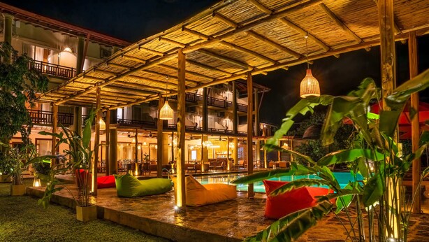 A covered outdoor area with seating and a pool. - Chaarya Lake  (Yala)