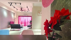 A modern living room with a black sofa, a dining table, and a ceiling fan. - Pavilionvillie M1T570 by Irainbow (Kinta)
