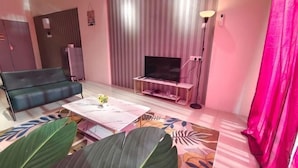 A living room with a sofa, a coffee table, a TV, and a curtain. - Pavilionvillie M1T570 by Irainbow (Kinta)
