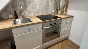 A kitchen with a sink, stove, oven, and wooden countertop. - Schönblick B7 House · Modern with a Balcony Next to the Ski Lift (Schöfweg)