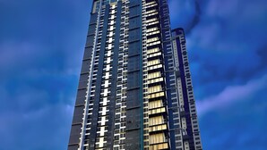 A tall, modern building with a prominent 'Space Residency' sign, featuring a mix of glass and metal facade, and a parking area in front. - Space Residency by A----Walk 100m to KSL (Johor Bahru)