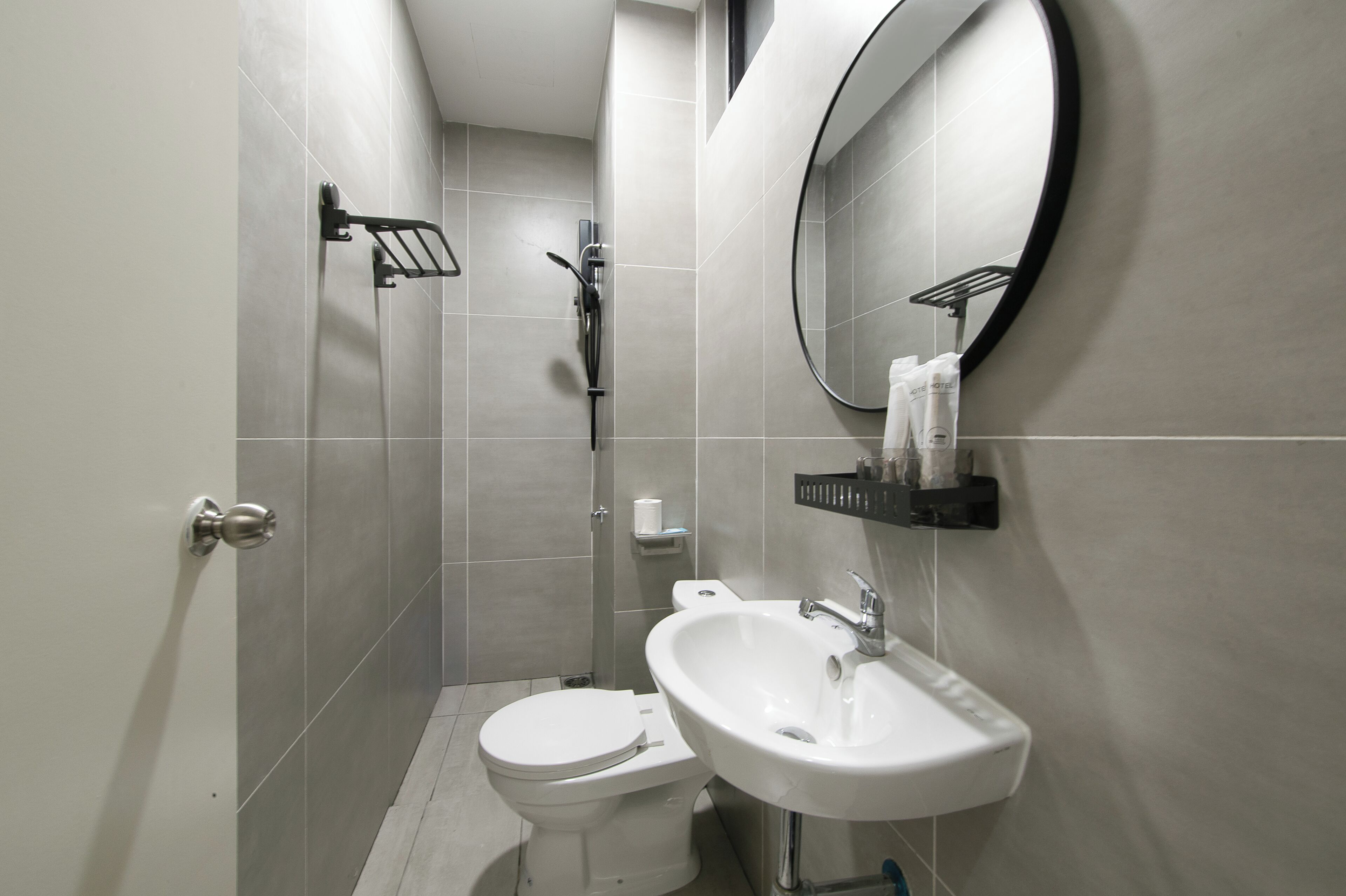 A modern bathroom with a toilet, sink, and shower.