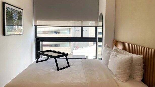 A bedroom with a bed, a window, and a framed picture on the wall. - w Comfortable 2BR in Cuauhtemoc (Mexico City)