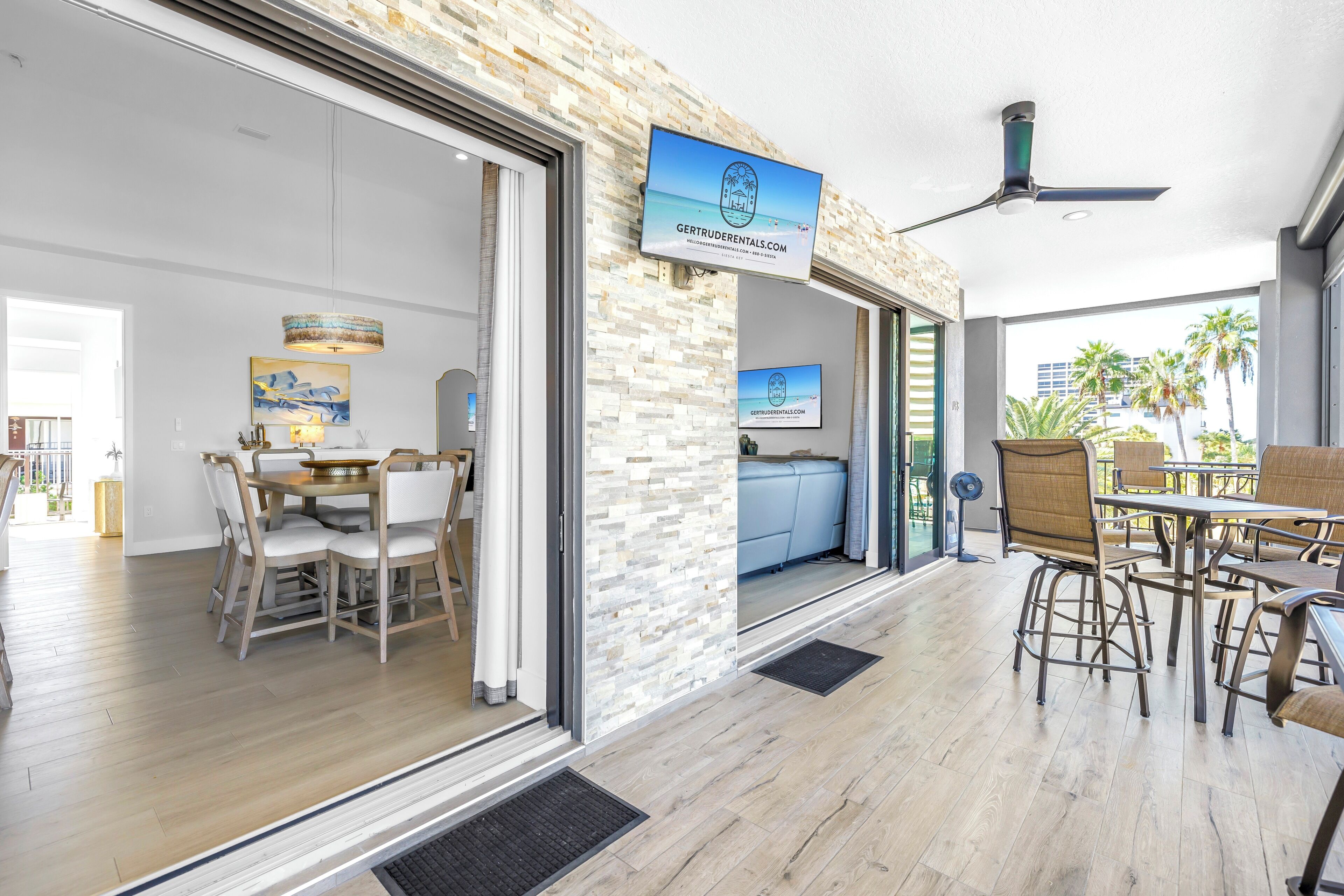 A modern interior with a dining area, a seating area with a view, and a sign for Gertruder Rentals.