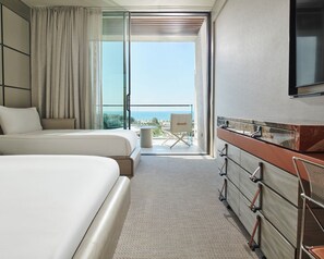 A hotel room with a bed, a dresser, a chair, and a balcony with a view. - Voyage Kundu (Antalya)