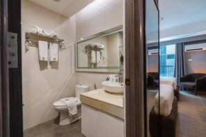 A modern bathroom with a toilet, sink, and towel rack. - S Resort El Nido Managed by H Hospitality (El Nido)