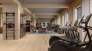 A spacious gym with treadmills, weight machines, and a pull-up bar area.