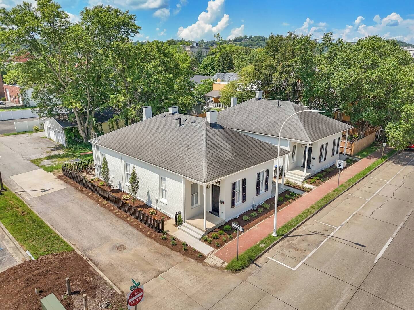 A two-story residential building with a front porch and a garage.