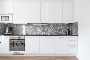 Comfort Apartment | Private kitchen | Full-size fridge, microwave, oven, stovetop