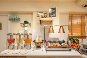 A breakfast buffet with various food items and beverages. - Bloom Hotel - Kakinada (Kakinada)