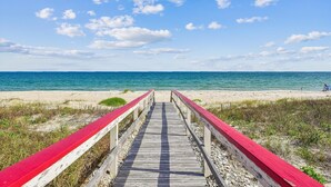A wooden boardwalk leading to a beach with a clear view of the ocean. - Welcome to Easy Does It! (St. George Island)