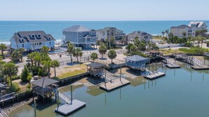 A coastal residential area with houses, docks, and a beach. - 7 Bedroom, Ocean Front Paradise - 1 To Sea (Garden City)