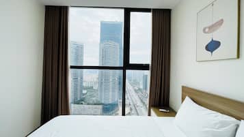 Deluxe Suite, City View | In-room safe, desk, laptop workspace, blackout drapes