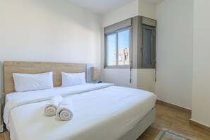 Apartment, 2 Bedrooms, Kitchen, City View | Desk, laptop workspace, blackout drapes, iron/ironing board