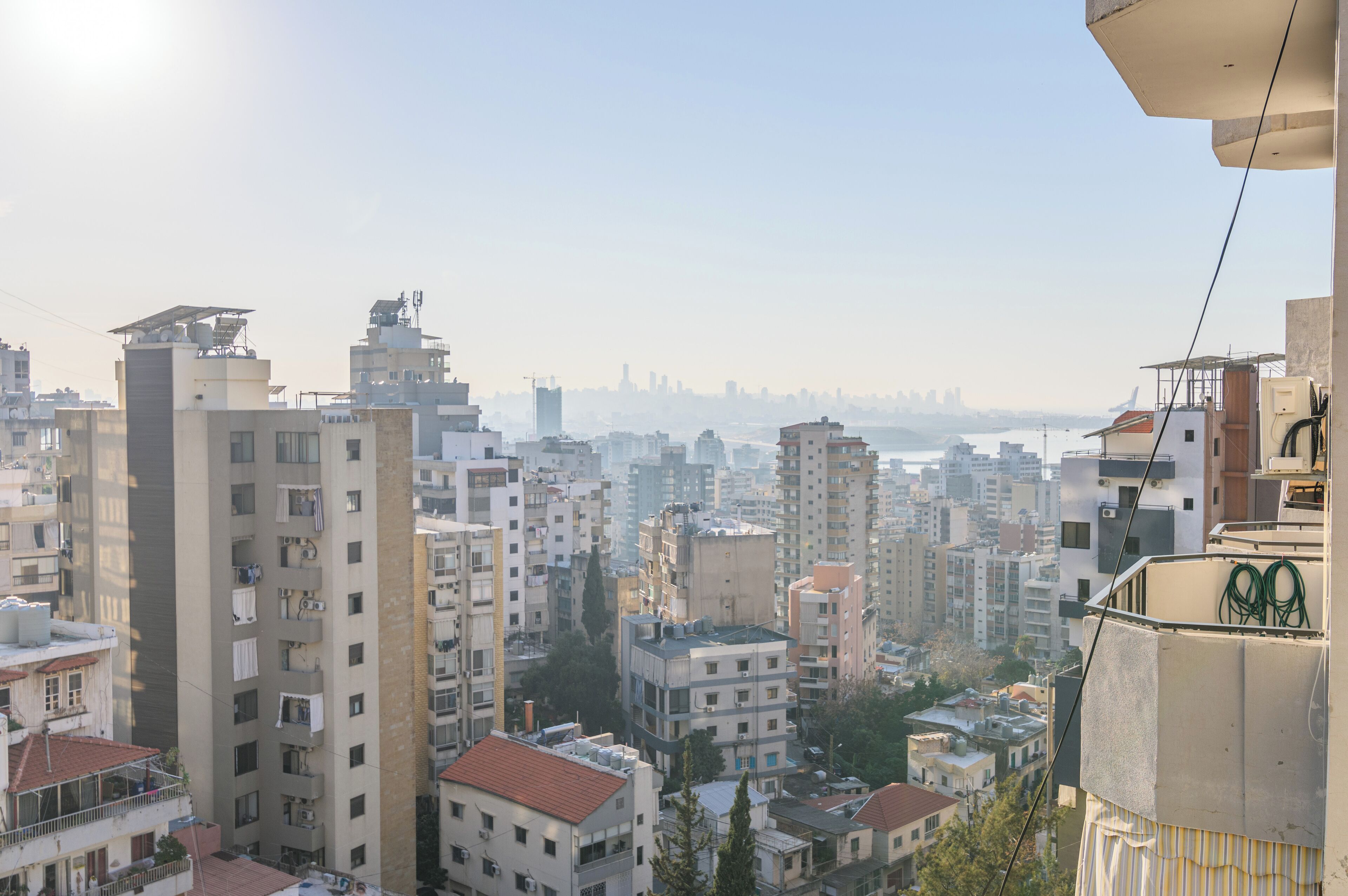 A densely packed urban area with high-rise buildings and a distant city skyline.