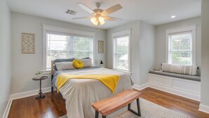 A bedroom with a bed, a bench, a ceiling fan, and a window seat. - 1 Mi to OKC Fair Park: Family-friendly Apt! (Oklahoma City)