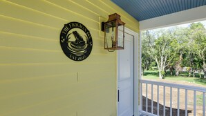 A yellow exterior wall with a frog logo and a lantern. - 1 Block to Loveland Bike Trail: 'the Frog Man Inn' (Loveland)