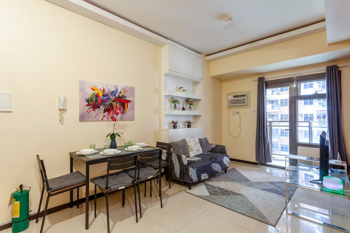 Standard Apartment, 1 Queen Bed with Sofa bed, Balcony, City View | Living room | 50-inch Smart TV with digital channels