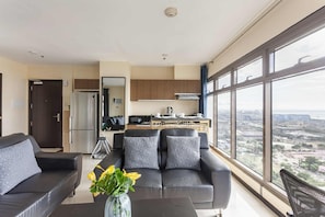 Signature Apartment, 1 Bedroom, Pool Access, Pool View | Living room | 50-inch Smart TV with digital channels