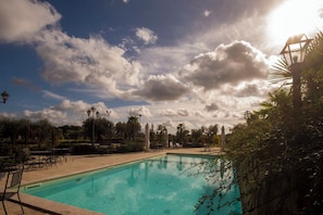Seasonal outdoor pool, open 8:00 AM to 8:00 PM, pool umbrellas