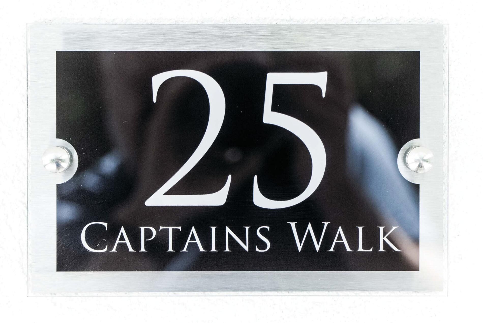 A sign with the number 25 and the text "Captains Walk".