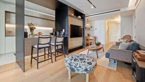 A modern apartment with a kitchen, dining area, and living room. - Luxury 5-Star Stay at Savoy Insular (Funchal)