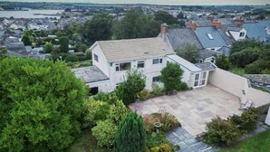 A two-story house with a large patio and a view of the surrounding neighborhood. - Longview - 4 Bedroom Holiday Home - Pembroke Dock (Pembroke Dock)