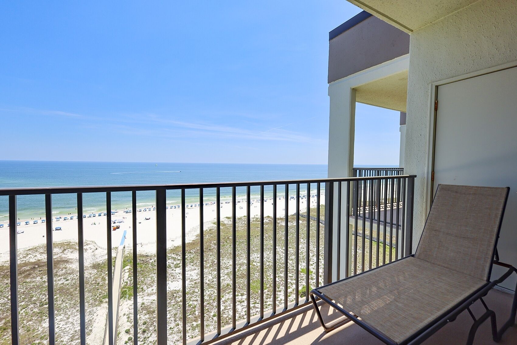 A balcony with a view of a beach and ocean.