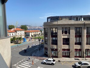 Vista de una calle con un edificio que presenta columnas imponentes y una fachada barroca.