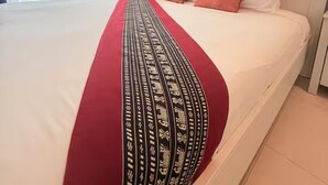 A hotel room with a large bed, an air conditioning unit, a window with curtains, and a nightstand. - Private Pool Villa • 4BR •Fast Wifi • Koh Chang (Tambon Ko Chang)