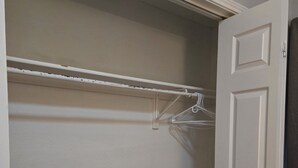 A closet with a white door, a wooden floor, and a white ceiling. - Private room in a Beautiful house Centrally Located  (Denton)
