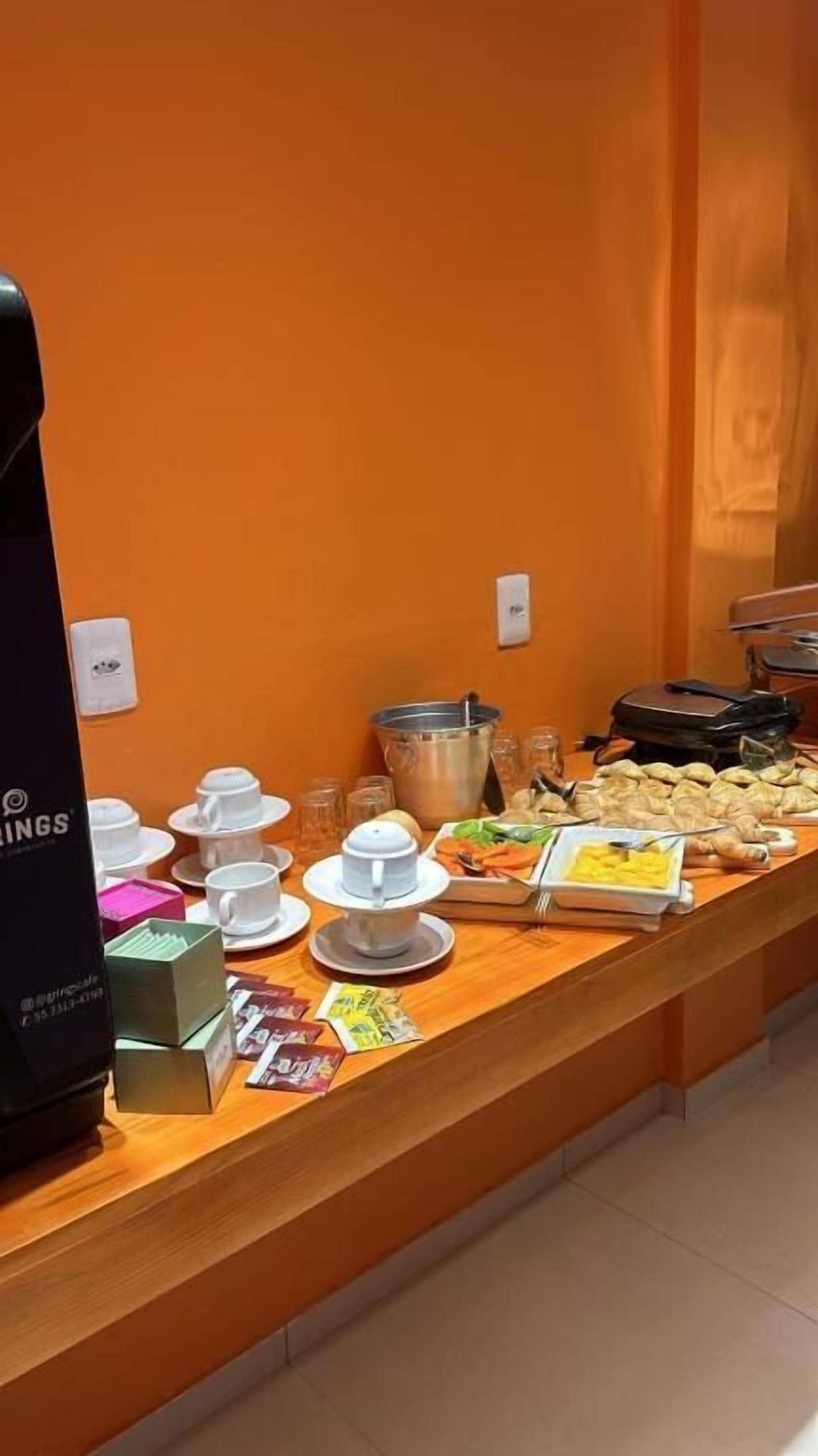 A buffet setup with various food items and utensils.