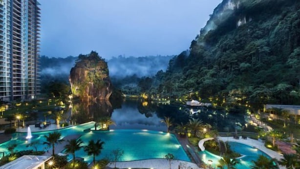 A resort with multiple swimming pools, a large rock formation, and lush greenery. - Ipoh All Suite Resort, Jalan Haven Ipoh (Kinta)