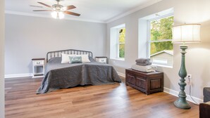 A bedroom with a bed, nightstands, a dresser, a floor lamp, and a ceiling fan. - Beautiful Getaway! 16+ppl and close to Chattanooga! (Ringgold)
