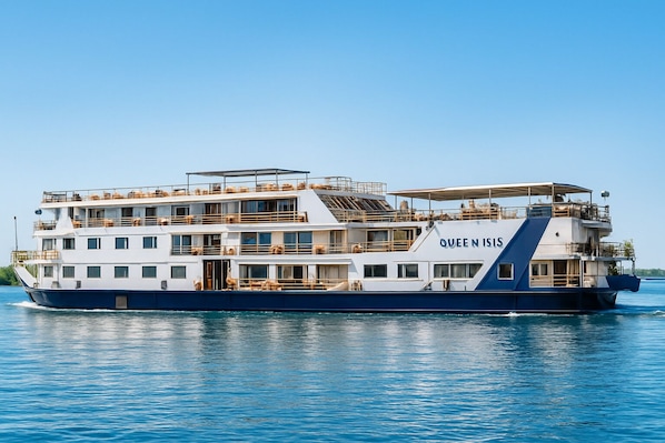A multi-deck cruise ship named 'Queen N Isis' with multiple levels of balconies and windows.