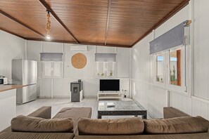 A compact living space with a kitchenette, a flat-screen TV, a dining area, and a seating arrangement. - Holiday Home 'El Encanto De Ronda' with Mountain View, Private Pool and Wi-Fi (Ronda)